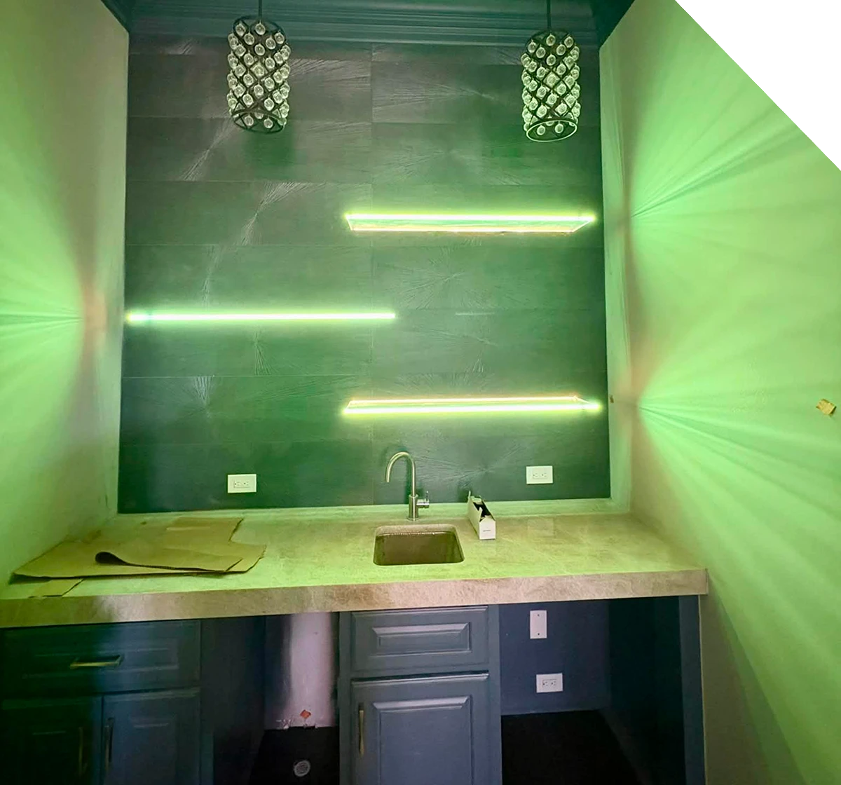 Modern bathroom with green lighting and sleek fixtures.